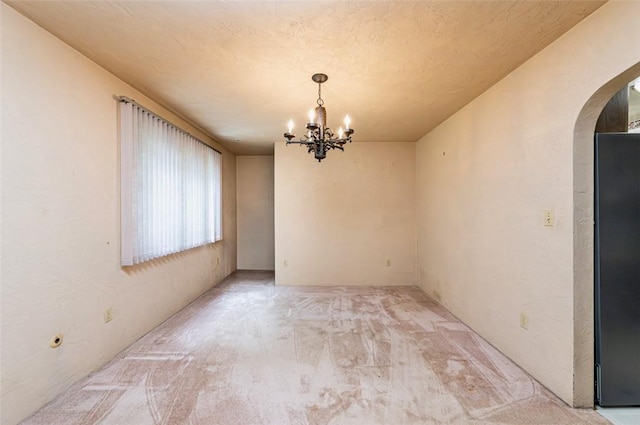 483 Twin Lakes Rd, Unity Twp, PA 15650 - unfurnished dining area with arched walkways, a chandelier, and light colored carpet