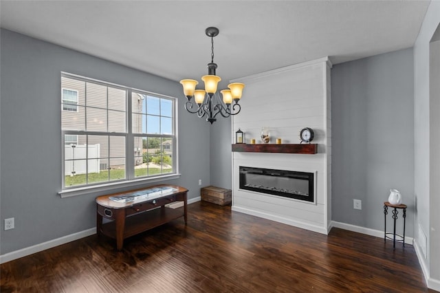294 Connoquenessing Main St, Connoquenessing Boro, PA 16033 - living area featuring a chandelier, a glass covered fireplace, and wood finished floors