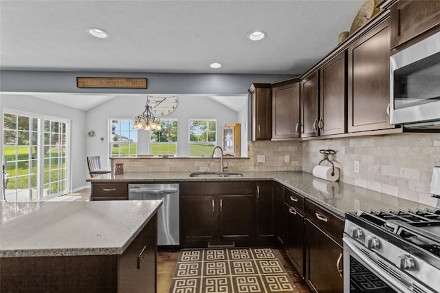 294 Connoquenessing Main St, Connoquenessing Boro, PA 16033 - kitchen featuring stainless steel appliances, backsplash, dark brown cabinets, light stone counters, and lofted ceiling