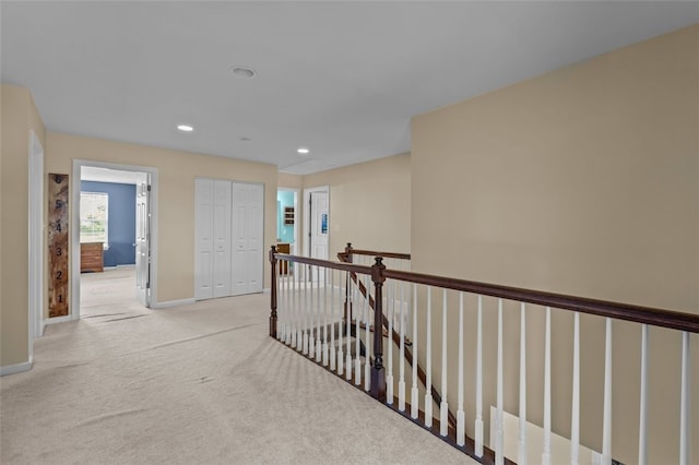 294 Connoquenessing Main St, Connoquenessing Boro, PA 16033 - hall with light colored carpet, recessed lighting, and an upstairs landing
