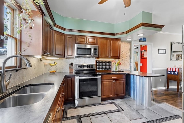 1101 6th Ave, Freedom, PA 15042 - kitchen with stainless steel appliances, tasteful backsplash, a ceiling fan, dark countertops, and crown molding