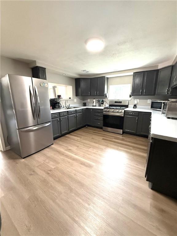 6028 Davidson Rd, Jamestown, PA 16134 - kitchen featuring appliances with stainless steel finishes, light countertops, and light wood-style floors