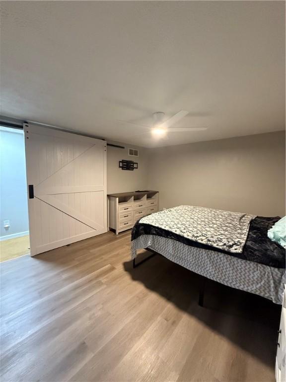 6028 Davidson Rd, Jamestown, PA 16134 - bedroom with light wood finished floors and ceiling fan