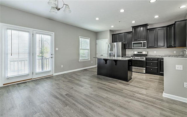 400 Fairmont Dr, Marshall, PA 15090 - kitchen featuring stainless steel appliances, a kitchen island, dark cabinets, a breakfast bar, and recessed lighting
