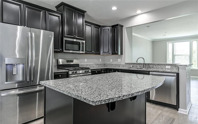 400 Fairmont Dr, Marshall, PA 15090 - kitchen with appliances with stainless steel finishes, dark cabinetry, a peninsula, crown molding, and a breakfast bar