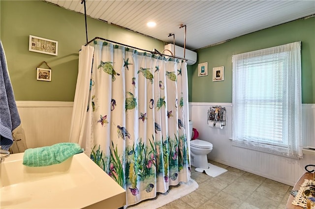 110 Pattison St, Evans City Boro, PA 16033 - bathroom with a wainscoted wall, curtained shower, a wall mounted air conditioner, and wooden walls