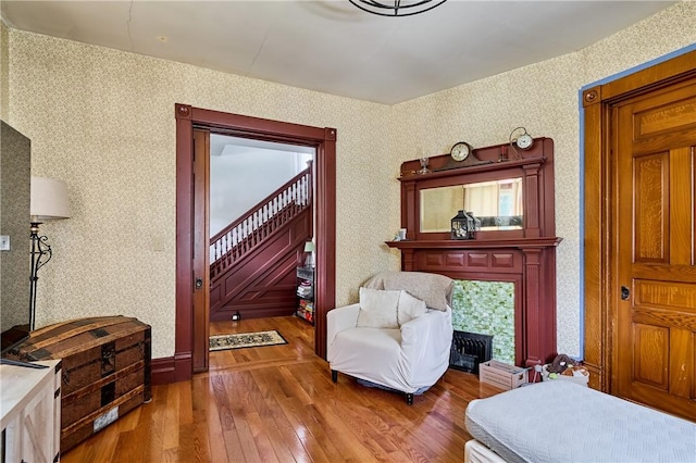 110 Pattison St, Evans City Boro, PA 16033 - sitting room featuring hardwood / wood-style floors, stairs, and wallpapered walls