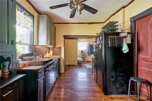 110 Pattison St, Evans City Boro, PA 16033 - kitchen featuring black appliances, ceiling fan, healthy amount of natural light, dark wood finished floors, and ornamental molding