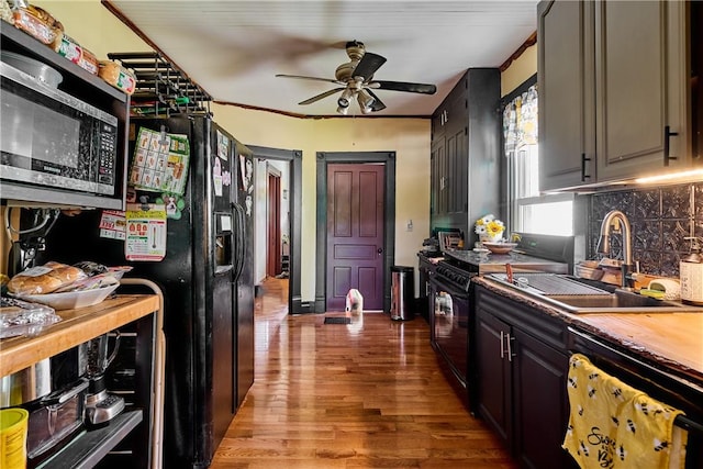 110 Pattison St, Evans City Boro, PA 16033 - kitchen featuring black appliances, ceiling fan, wood finished floors, tasteful backsplash, and ornamental molding