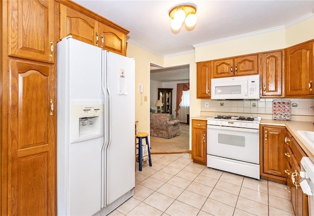 3912 Milton Dr, Richland, PA 15044 - kitchen featuring white appliances, light countertops, brown cabinets, light tile patterned floors, and crown molding