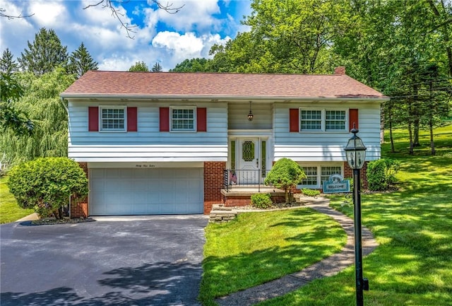 3912 Milton Dr, Richland, PA 15044 - bi-level home with driveway, brick siding, an attached garage, and a front lawn