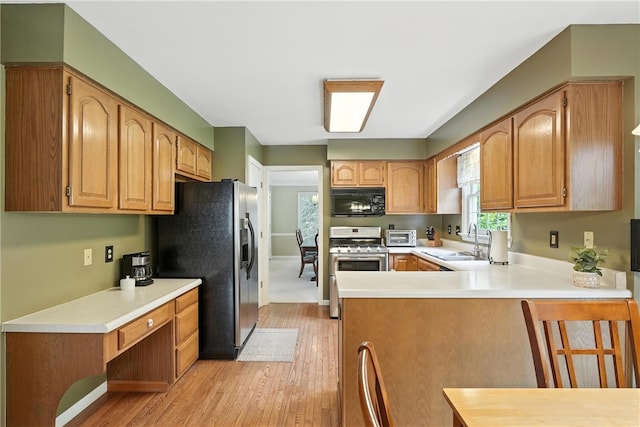 708 Reiser Ct, Cranberry Twp, PA 16066 - kitchen with stainless steel appliances, light wood finished floors, a peninsula, and light countertops