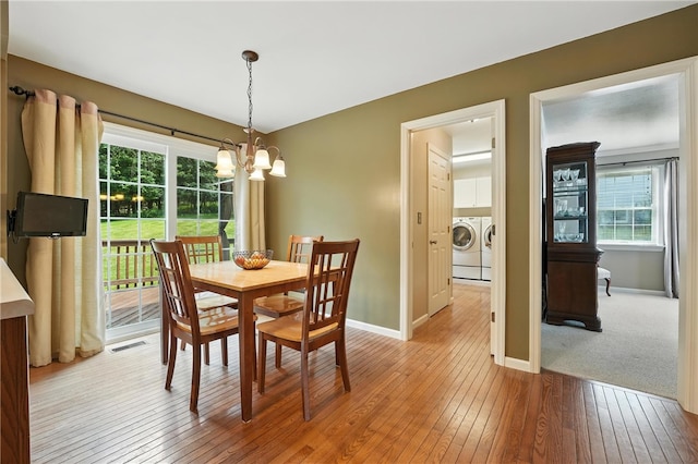 708 Reiser Ct, Cranberry Twp, PA 16066 - dining space featuring washing machine and dryer, a chandelier, and light wood-style floors