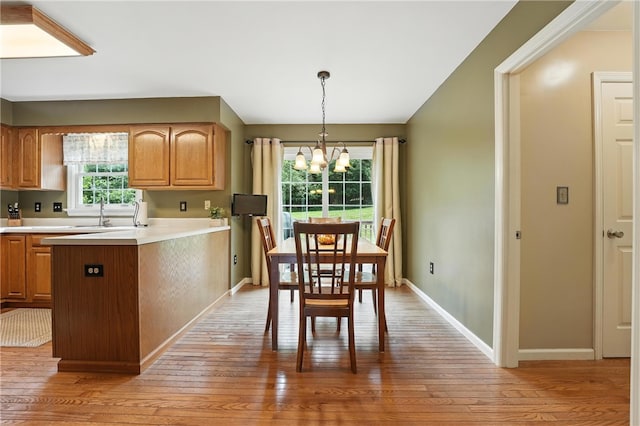 708 Reiser Ct, Cranberry Twp, PA 16066 - kitchen featuring a chandelier, light wood finished floors, light countertops, and pendant lighting