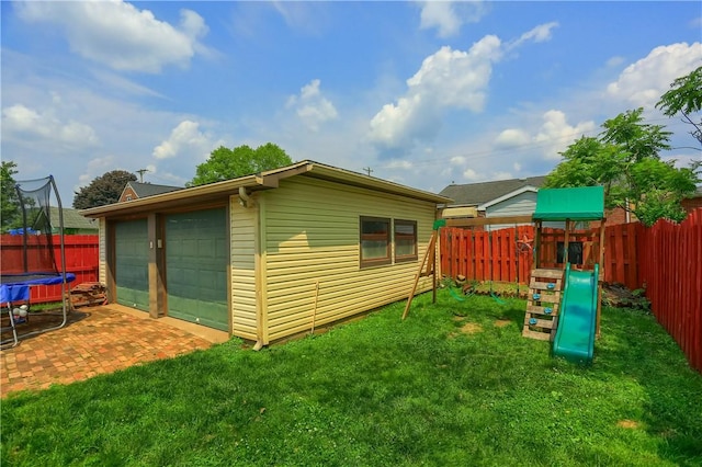 520 38th St, Beaver Falls, PA 15010 - view of side of home with a trampoline, a fenced backyard, a playground, and a garage