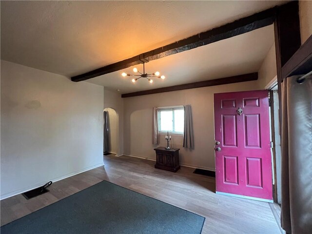 2220 Cronemeyer St, Mckeesport, PA 15132 - entryway featuring arched walkways, a chandelier, light wood-style flooring, and beamed ceiling