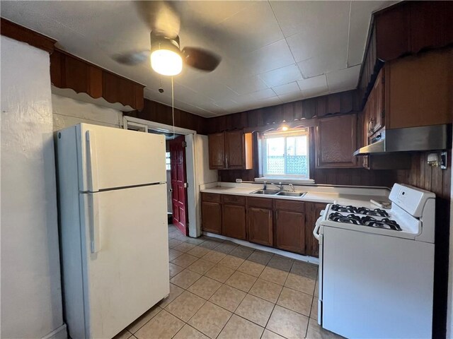 2220 Cronemeyer St, Mckeesport, PA 15132 - kitchen with white appliances, under cabinet range hood, light countertops, a ceiling fan, and light tile patterned flooring