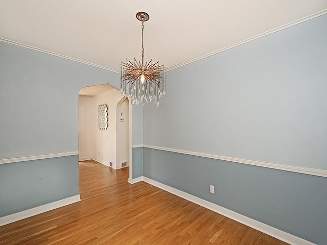 376 Mcclellan Dr, Pleasant Hills, PA 15236 - spare room featuring arched walkways, wood finished floors, a chandelier, and ornamental molding