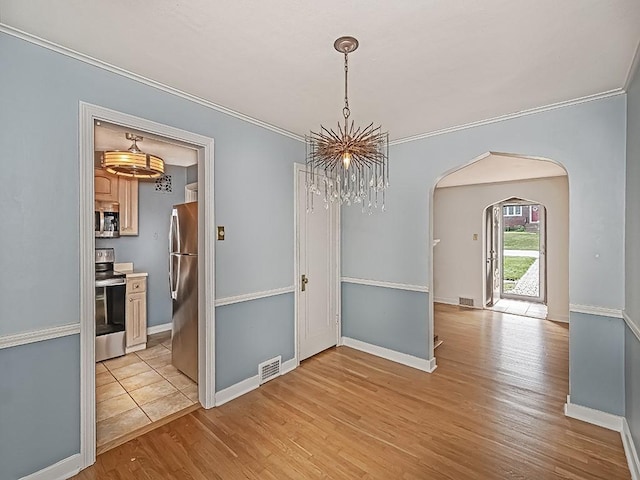 376 Mcclellan Dr, Pleasant Hills, PA 15236 - unfurnished dining area with arched walkways, light wood-type flooring, crown molding, and a chandelier