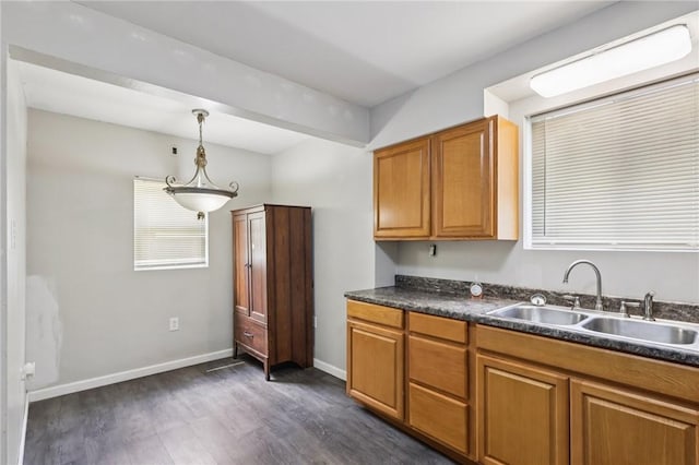 130 Pershing Blvd, Nemacolin, PA 15351 - kitchen with dark countertops, dark wood-style floors, brown cabinets, and decorative light fixtures