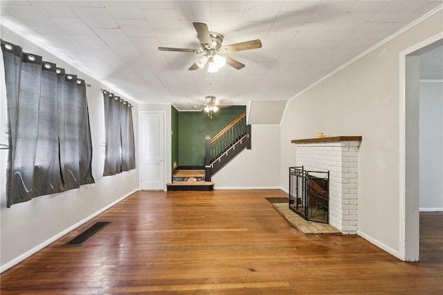 130 Pershing Blvd, Nemacolin, PA 15351 - unfurnished living room with ornamental molding, ceiling fan, stairway, a fireplace, and hardwood / wood-style flooring