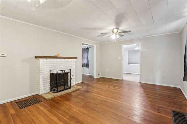 130 Pershing Blvd, Nemacolin, PA 15351 - unfurnished living room with ceiling fan, a brick fireplace, wood-type flooring, and crown molding