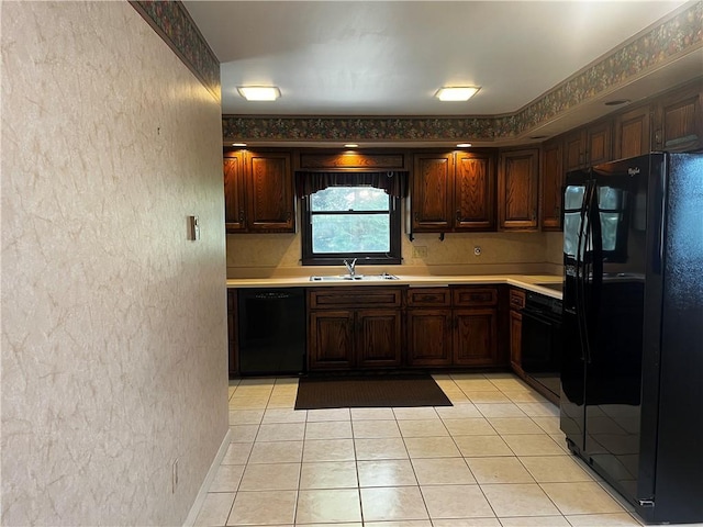 15 S 7th St, Youngwood, PA 15697 - kitchen featuring black appliances, a textured wall, light countertops, light tile patterned floors, and dark brown cabinetry