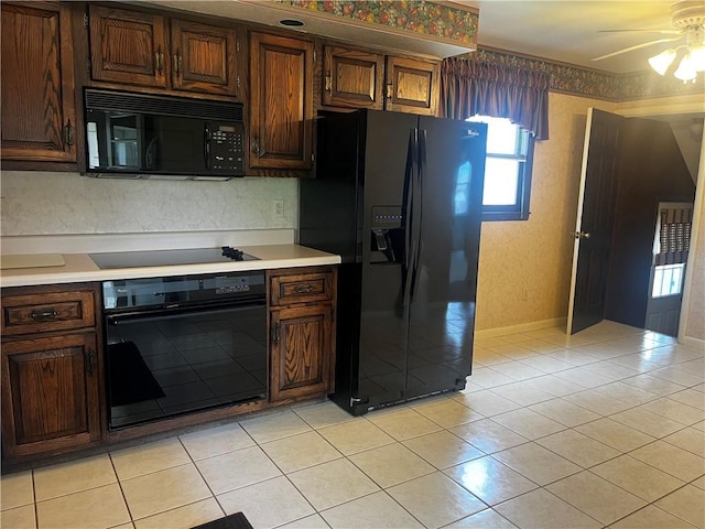 15 S 7th St, Youngwood, PA 15697 - kitchen featuring black appliances, light countertops, light tile patterned floors, and a ceiling fan