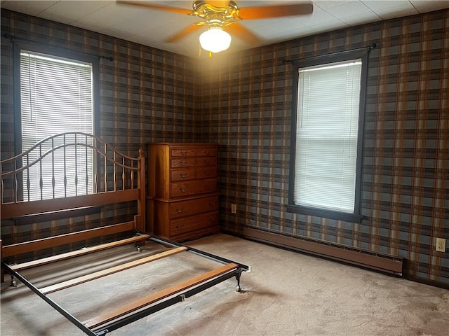 15 S 7th St, Youngwood, PA 15697 - bedroom with a baseboard heating unit, carpet, wallpapered walls, and a ceiling fan