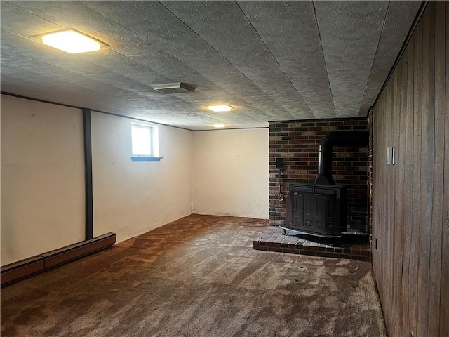 15 S 7th St, Youngwood, PA 15697 - below grade area with a wood stove, carpet floors, and wooden walls