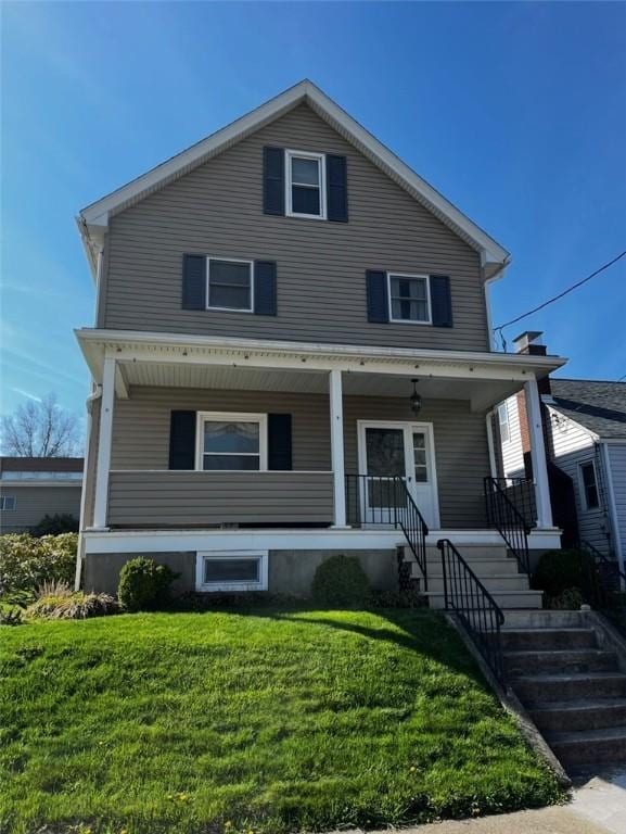 15 S 7th St, Youngwood, PA 15697 - traditional style home featuring covered porch, a front yard, and stairs