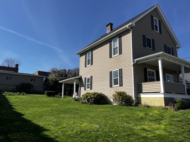 15 S 7th St, Youngwood, PA 15697 - rear view of property with covered porch, a chimney, and a yard