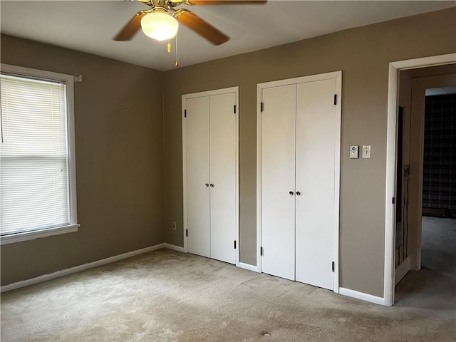 15 S 7th St, Youngwood, PA 15697 - unfurnished bedroom featuring two closets, carpet floors, and ceiling fan