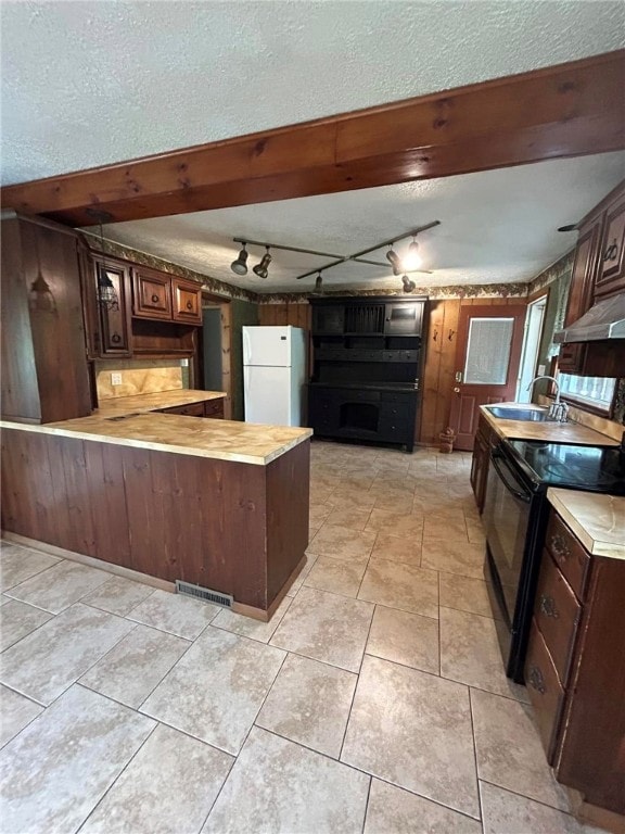 192 Yellow Creek Rd, Lancaster Twp, PA 16037 - kitchen featuring freestanding refrigerator, black electric range oven, rail lighting, a textured ceiling, and a peninsula