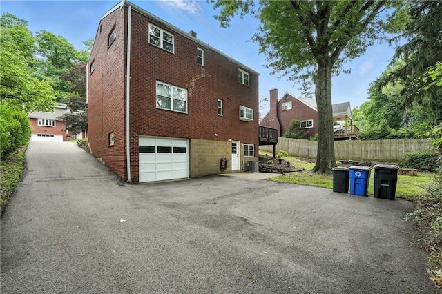 445 Pacific Ave, Forest Hills Boro, PA 15221 - rear view of house with an attached garage, driveway, and brick siding