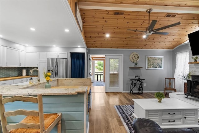 12187 Mantor St, Conneaut Lake, PA 16316 - kitchen featuring stainless steel fridge with ice dispenser, a ceiling fan, white cabinets, tasteful backsplash, and lofted ceiling