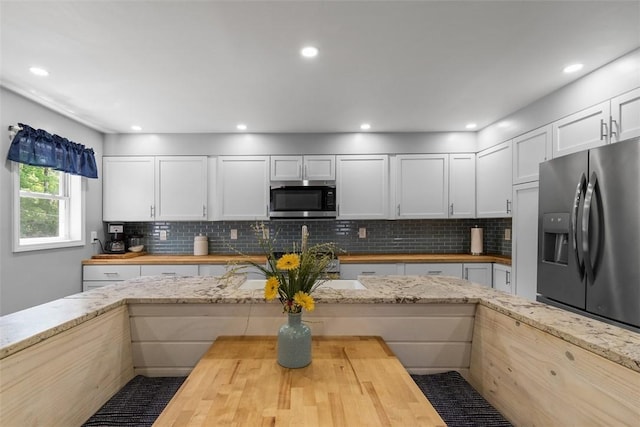 12187 Mantor St, Conneaut Lake, PA 16316 - kitchen featuring wooden counters, appliances with stainless steel finishes, backsplash, white cabinetry, and recessed lighting