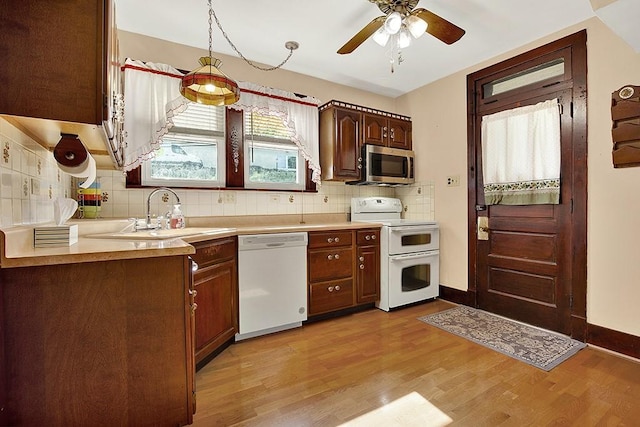 4214 Northern Pike, Monroeville, PA 15146 - kitchen featuring white appliances, light wood-type flooring, light countertops, and tasteful backsplash
