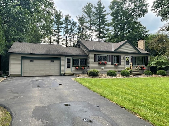 17 Evergreen, Hempfield Twp, PA 16125 - ranch-style home featuring asphalt driveway, a chimney, a garage, a front yard, and roof with shingles