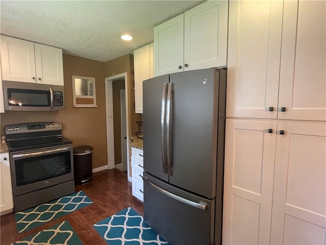 17 Evergreen, Hempfield Twp, PA 16125 - kitchen featuring appliances with stainless steel finishes, white cabinets, a textured ceiling, dark wood-style flooring, and recessed lighting