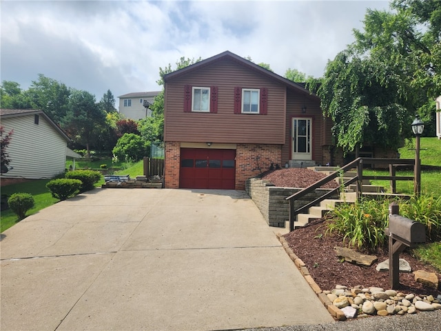 4095 Overlook St, South Park, PA 15129 - tri-level home featuring brick siding, an attached garage, driveway, and stairway