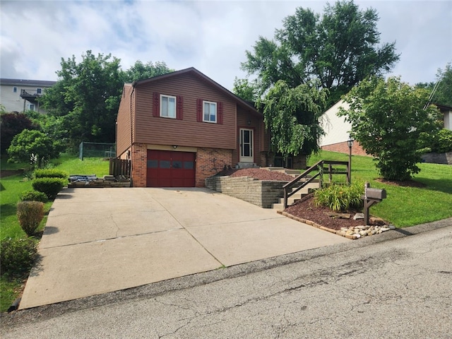 4095 Overlook St, South Park, PA 15129 - tri-level home featuring brick siding, stairs, a garage, concrete driveway, and a front lawn