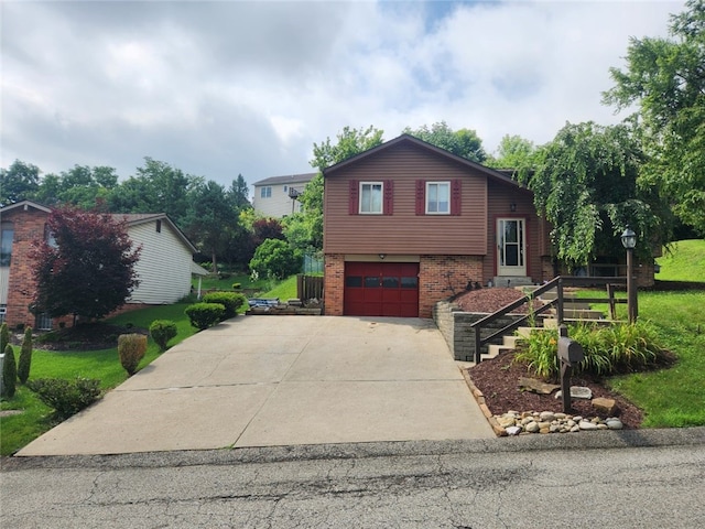 4095 Overlook St, South Park, PA 15129 - split level home with brick siding, a garage, and concrete driveway