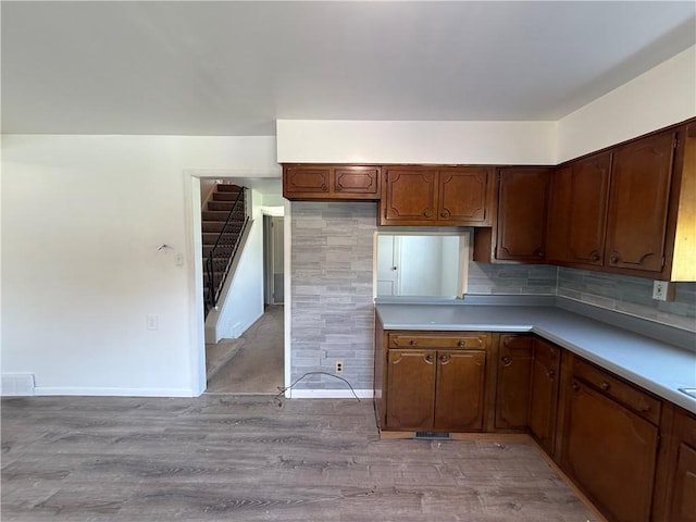 3170 Dutch Ridge Rd, Brighton Twp, PA 15009 - kitchen featuring light wood-style flooring, tasteful backsplash, and light countertops