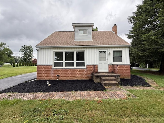 3170 Dutch Ridge Rd, Brighton Twp, PA 15009 - bungalow-style house with brick siding, a chimney, a front yard, and roof with shingles