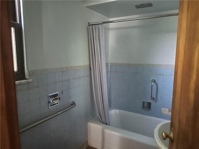 998 Chartiers Ave, Carnegie, PA 15106 - full bathroom featuring tile walls, shower / tub combo with curtain, and a wainscoted wall
