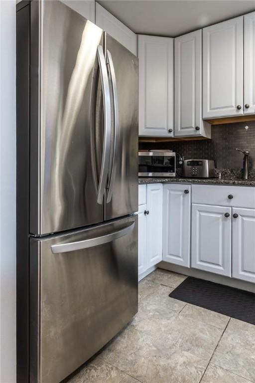 2207 Kenzie Dr, Robinson Twp, PA 15205 - kitchen with stainless steel appliances, white cabinetry, dark stone countertops, and backsplash