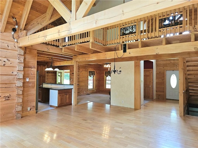 459 Big Knob Rd, New Sewickley Twp, PA 15074 - unfurnished living room with high vaulted ceiling, wooden walls, light wood-style floors, a chandelier, and a wooden ceiling with exposed beams