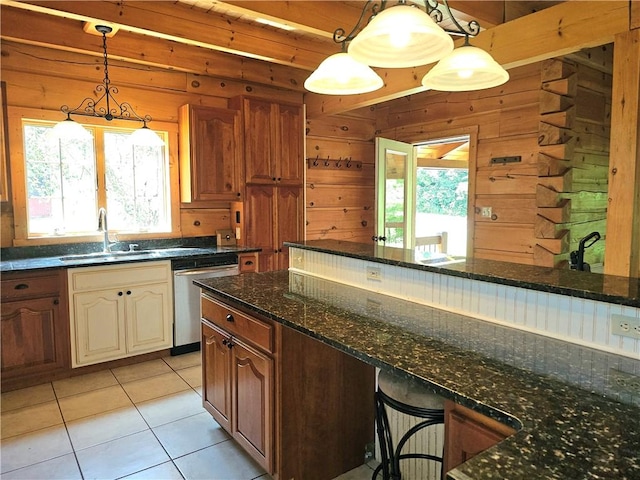 459 Big Knob Rd, New Sewickley Twp, PA 15074 - kitchen with stainless steel dishwasher, plenty of natural light, wooden walls, light tile patterned floors, and dark stone countertops