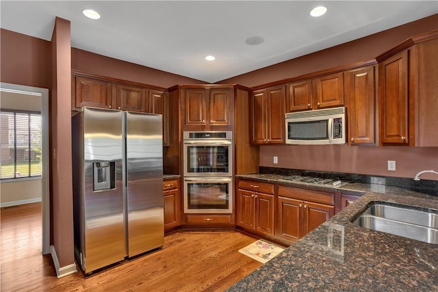 371 Marshall Heights Dr, Marshall, PA 15090 - kitchen with appliances with stainless steel finishes, light wood finished floors, dark stone countertops, recessed lighting, and brown cabinets